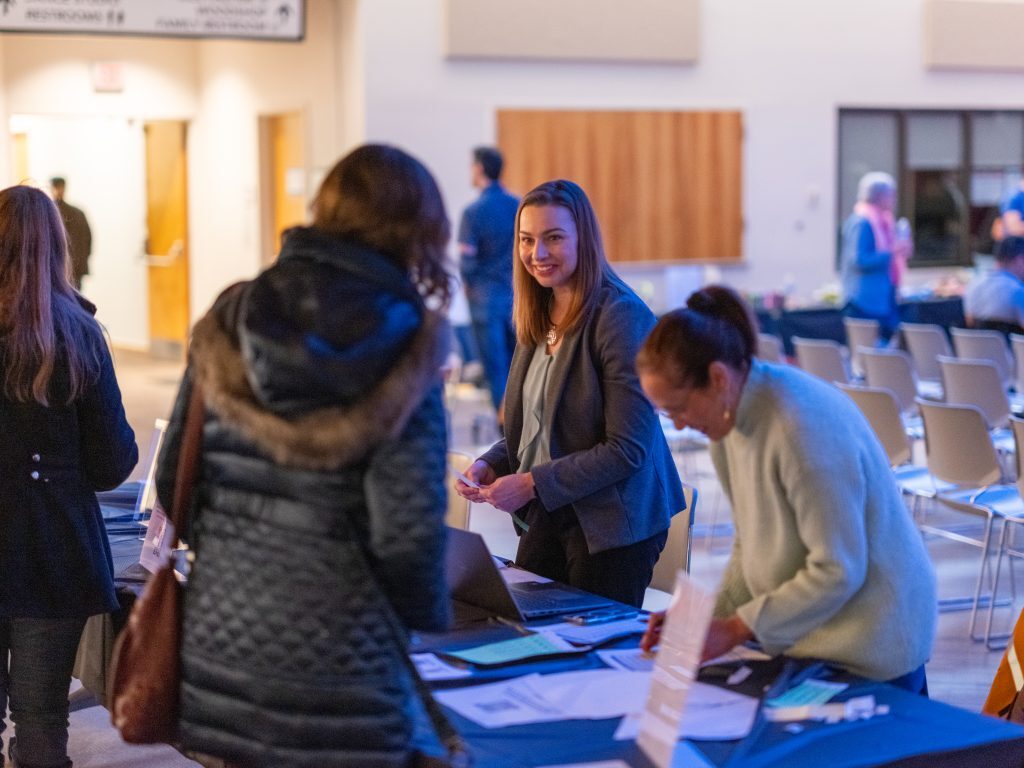 Volunteers checking in guests for an improv show